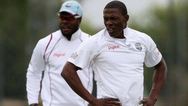 Ili-Sheldon-Cottrell-of-West-Indies-stares-back-up-the-pitch-with-Kirk-Edwards-L-during-day.jpg